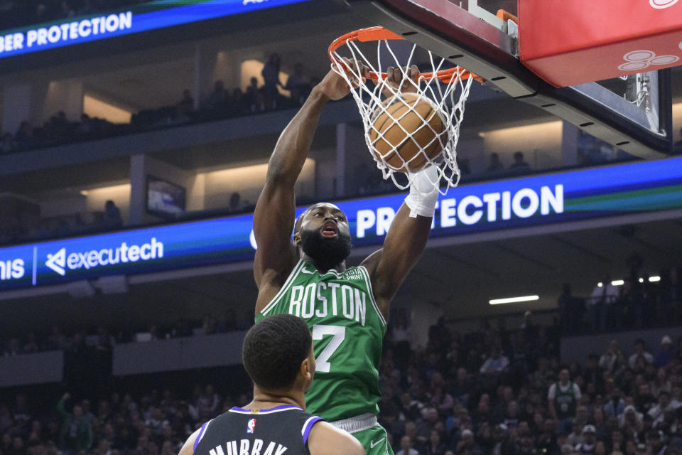 Boston Celtics guard Jaylen Brown (7) dunks the ball over Sacramento Kings forward Keegan Murray during the first quarter of an NBA basketball game in Sacramento, Calif., Wednesday, Dec. 20, 2023. (AP Photo/Randall Benton)