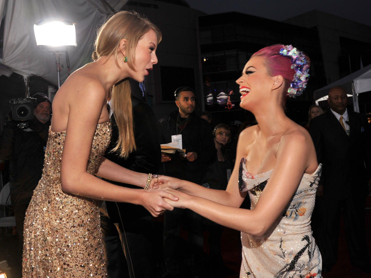 Taylor Swift (L) and Katy Perry arrive at the 2011 American Music Awards held at Nokia Theatre L.A. LIVE on November 20, 2011 in Los Angeles, California.  (Photo by Lester Cohen/AMA2011/WireImage)