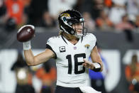 Jacksonville Jaguars quarterback Trevor Lawrence (16) throws during the first half of an NFL football game against the Cincinnati Bengals, Thursday, Sept. 30, 2021, in Cincinnati. (AP Photo/Michael Conroy)