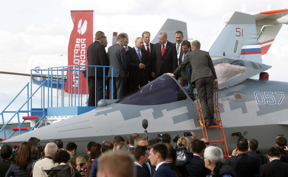 Russian President Vladimir Putin, 3rd left, Russian Industry and Trade Minister Denis Manturov, 4th left, and Turkish President Recep Tayyip Erdogan, 5th left, inspect Sukhoi Su-57 fifth-generation fighter during the MAKS-2019 International Aviation and Space Show in Zhukovsky, outside Moscow, Russia, Tuesday, Aug. 27, 2019. Turkish President is on a short working visit in Russia. (Maxim Shipenkov/Pool Photo via AP)