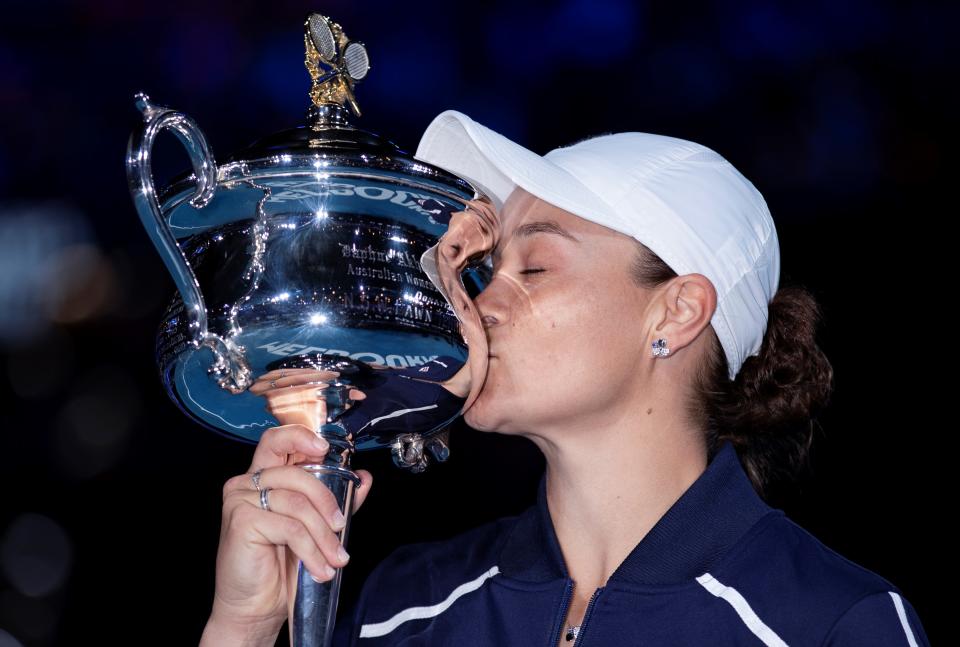 Seen here, Ashleigh Barty kisses the championship trophy after winning the women's singles final at the 2022 Australian Open.