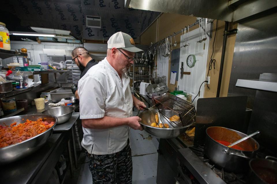 Ron Fields, a sous chef at Catering Capers, makes wings for an order Wednesday, Jan. 31, 2024.