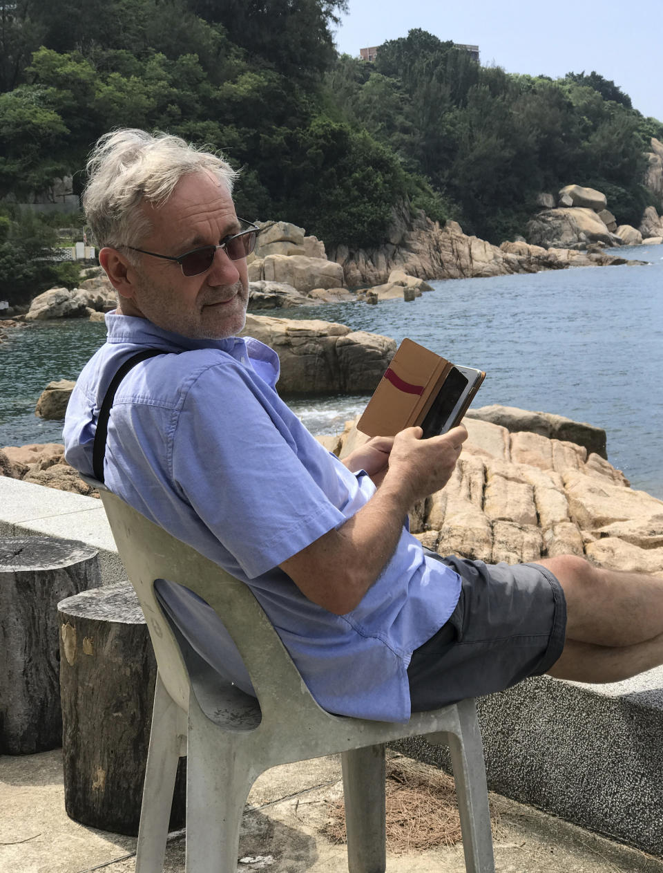 CORRECTS THAT WOLF DIED WEDNESDAY, NOT TUESDAY - Award-winning Hong Kong-based photographer Michael Wolf is photographed in Cheung Chau, Hong Kong in 2016. Hong Kong art gallery director Sarah Greene said that Wolf, known for his work depicting mega-cities, has died Wednesday, April 24, 2019 at his home. She said he was 64. Wolf won first prize in the World Press Photo competition in 2005 and 2010. (Blue Lotus Gallery via AP)