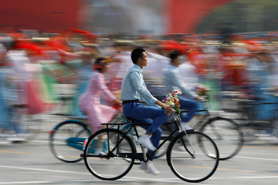 Performers ride bicycles during a parade marking the 70th founding anniversary of People's Republic of China, on its National Day in Beijing, China October 1, 2019. (Photo: Thomas Peter/Reuters)