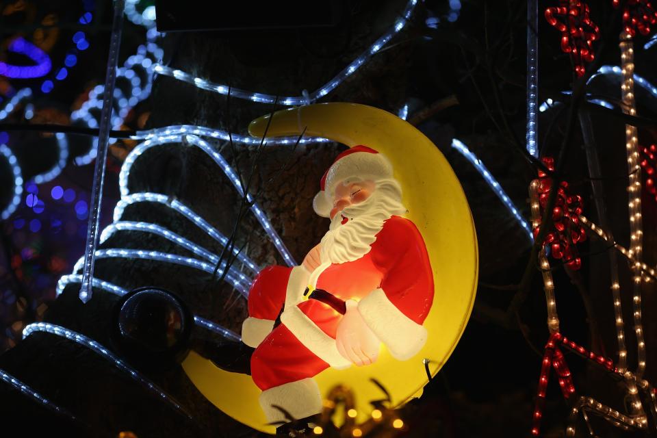 MELKSHAM, ENGLAND - DECEMBER 08: Christmas festive lights adorn a detached house in a suburban street in Melksham, December 8, 2012 in Melksham, England. The lights, a popular festive attraction, have returned to the town after a two-year absence and have raised thousands of pounds for charity for a local hospice, Dorothy House. The display, which is estimated to involve over 100,000 bulbs, worth over 30,000 GBP and even needed an up-rated electricity supply installed to cope with the additional power needed, is the brainchild of householder and electrician Alex Goodhind. This year, the display which Mr Goodhind began fifteen years ago now takes a team of professional electricians five weeks to complete, and even includes a snow machine. (Photo by Matt Cardy/Getty Images)