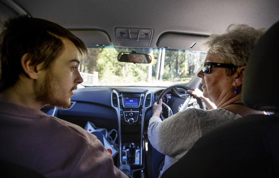 Deb Ware, right, drives her son, Sam, back to her home for the first time since she last found him overdosing there three weeks earlier in Fountaindale, Central Coast, Australia, Friday, July 19, 2019. A couple weeks earlier, he says, he was trying to sleep on the train but couldn't stop crying, thinking about how badly he had hurt his mother. In his bed at the men's shelter in Sydney, he lay awake all night, thinking of her pain. (AP Photo/David Goldman)