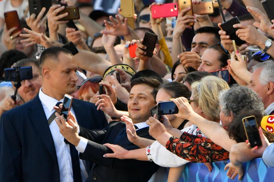 Vladimir Zelensky was sworn in as Ukraine’s sixth president on Monday morning, with the one-time showman dramatically vowing to dissolve parliament and provoke snap parliamentary elections. Mr Zelensky, a rookie politician, has long indicated he intended to disband the Supreme Rada, which was elected in 2014 and is largely hostile to him. But it was not immediately clear whether he had the legal authority to do so, and judicial arguments are likely to follow. In a punchy 40-minute inauguration speech, Mr Zelensky hit on themes of anti-establishmentarianism and inclusivity. The administration he was replacing had done nothing to make many Ukrainians feel Ukrainian, he said. His term would be different - and would work for all “regardless of who they voted for.” It was “a common victory.”“Every one of us has taken the oath today,” he said. “Each of us carries a responsibility for the Ukraine that we want to leave to our children.” Mr Zelensky said his "main priority" was to bring peace to eastern Ukraine, where a war with Russian-backed militias has been raging for the past five years. To the end of “stopping heroes dying,” he was ready to do “anything,” right up to sacrificing “popularity and post.” At several points, Mr Zelensky obviously reached out to the Russian-speaking east of the country, who he said had been forgotten. He also promised citizenship to anyone “wishing to build the new Ukraine." The rhetoric was demonstrably inclusive, and contrasted strongly with the ethnic nationalism espoused by his predecessor Petro Poroshenko, who was sat among several dozen foreign dignitaries in parliament.The inclusive tone also provoked an obvious reaction from nationalistic elements in parliament. At one point, the populist MP Oleh Lyashko even entered into dialogue with him, ostensibly over his use of Russian. “Enough, Mr Lyashko,” was President Zelensky’s response. “Enough dividing people. We are all Ukrainians. Ukraine is what is written on our passport.” Ahead of the ceremony, Mr Zelensky’s aides promised a show that would ditch protocol. So it was to be. He arrived at parliament on foot, ditching the presidential motorcade. Following his speech, he left parliament for a victory lap, giving high-fives to the crowds he had invited to attend. It was an obvious exhibition of his folksy manner and overwhelming popularity. It also seemed to be a declaration of intent to a parliament he had just taken on. Ukraine’s parliamentary-presidential balance of power undoubtedly presents Mr Zelensky with his biggest challenge. The president has only limited powers of appointment, cannot fire ministers, and cannot pass legislation without parliamentary approval. He also has few obvious allies in parliament. Mr Zelensky’s desire to dissolve the body and trigger fresh elections is understandable enough. But the logistics of doing so are more complicated than he suggested on Monday, and hostile parliamentarians are likely to put up a fight. According to Ukrainian law, the president can dissolve parliament if and when there is no prospect of a working coalition. But a quirk of the law also allows a coalition 30 days to establish itself. The law also states that the president cannot break up the parliament in the six months prior to ordinary parliamentary elections that were scheduled for October. This combination appeared to be behind to be the reasoning behind the 17 May announcement by People’s Front, a junior coalition partner, that it was leaving the coalition. Many assumed the manoeuvre had removed the window of opportunity for Mr Zelensky to call early elections. On his first day in office, Ukraine’s new president boldly challenged those assumptions. With legal challenges inevitable. Mr Zelensky is banking that his popular backing will triumph over matters of procedure. “Lawyers say there are grounds to dissolve, though that will be argued in court,” suggested the independent political expert Vladimir Fesenko in comments to The Independent.“It may be irrelevant. In Ukraine, the logic of politics always dominates the logic of law."