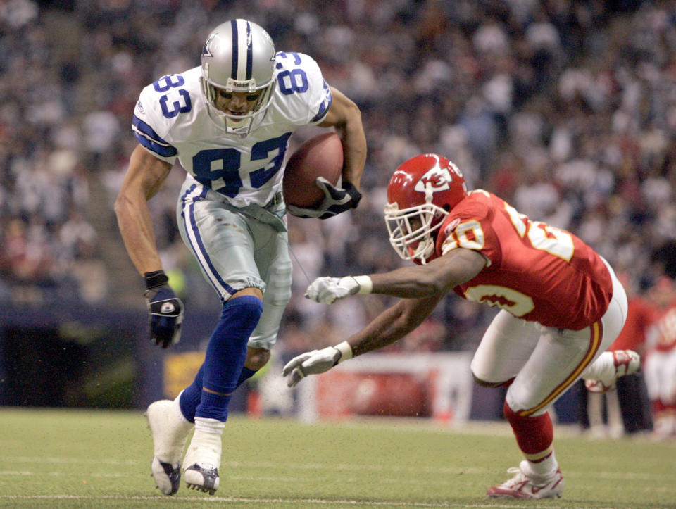 Dallas Cowboys' Terry Glenn advoids a tackle by Kansas City Chiefs corner back Benny Sapp on the way to a 6-yard touckdown run in Irving, Texas, on Sunday, Dec. 11, 2005. The Dallas Cowboys know that if they can get Terry Glenn involved, the offense will be productive.  (AP Photo/Donna McWilliam)