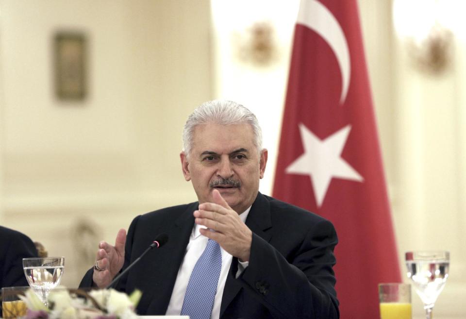 Turkey's Prime Minister Binali Yildirim speaks to a group of foreign journalists in Ankara, Turkey, Thursday, March 9, 2017. Yildirim said a state of emergency that was imposed following the failed coup attempt in July will be extended "for a bit longer."(AP Photo/Burhan Ozbilici)
