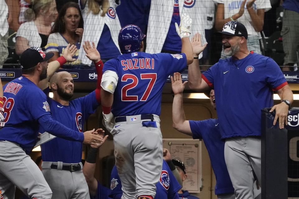 Chicago Cubs' Seiya Suzuki is congratulated after hitting an inside-the-park home run during the ninth inning of a baseball game against the Milwaukee Brewers Monday, July 4, 2022, in Milwaukee. (AP Photo/Morry Gash)