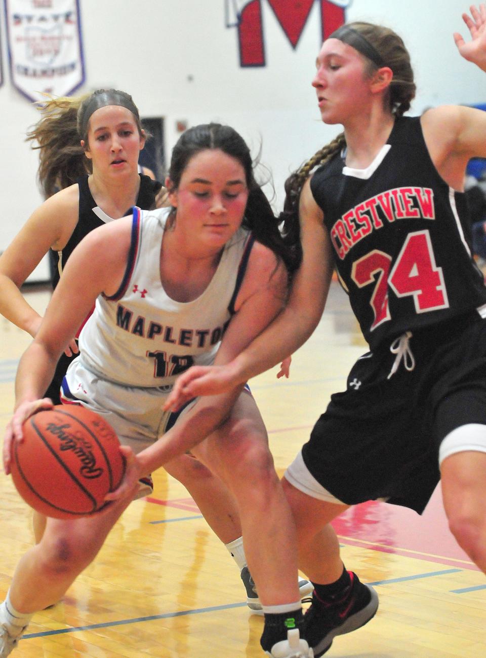 Mapleton High School’s Heidi Earl (12) drives toward the basket against the defense of Crestview High School’s Emma Aumend (24) during basketball action at Mapleton High School Wednesday, Feb. 9, 2022. LIZ A. HOSFELD/FOR TIMES-GAZETTE.COM