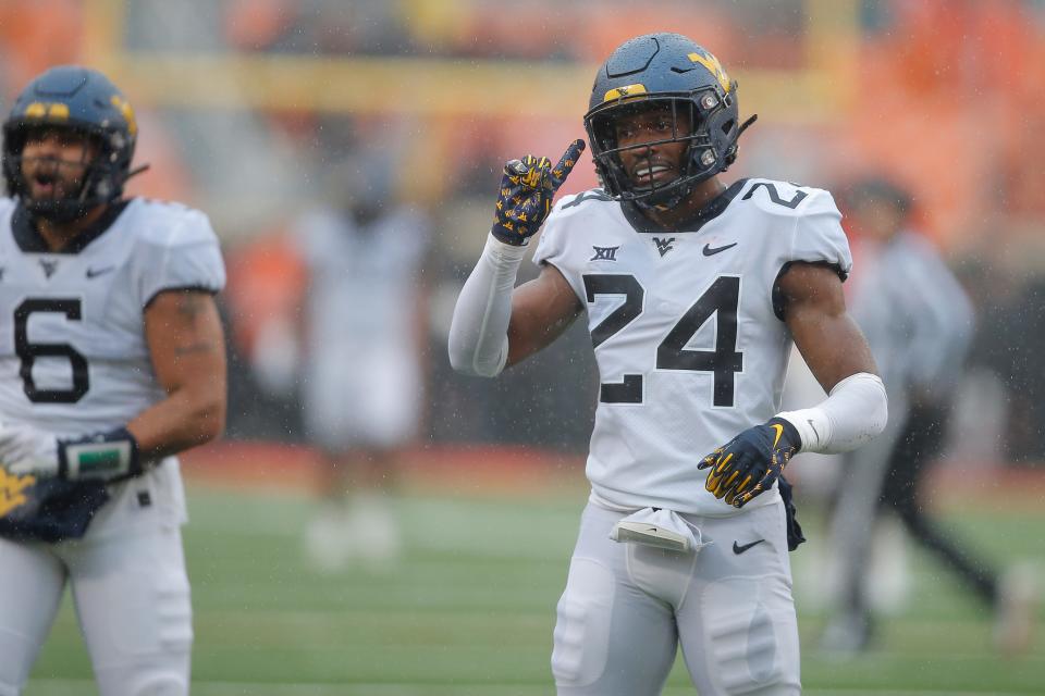 West Virginia safety Marcis Floyd (24) gestures after an Oklahoma State incompletion late in the fourth quarter Saturday.