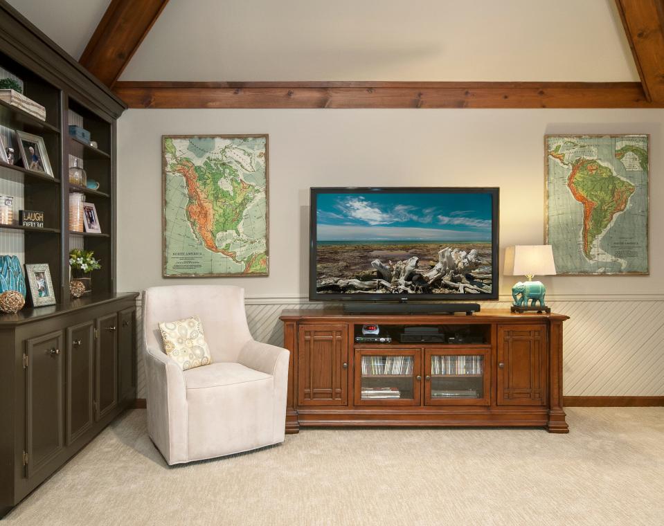 Though this room boasts darker elements, the light walls, ceilings, and floors keep it from feeling too heavy in this redesigned living room in Louisville.