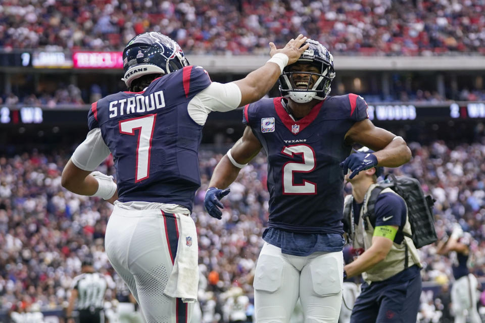 Houston Texans wide receiver Robert Woods (2) celebrates his touchdown reception with quarterback C.J. Stroud (7) in the first half of an NFL football game against the New Orleans Saints in Houston, Sunday, Oct. 15, 2023. (AP Photo/Eric Christian Smith)