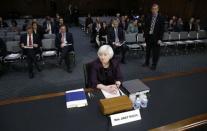 Federal Reserve Chair Janet Yellen takes her seat to testify at a Senate Banking, Housing and Urban Affairs Committee hearing on "Semiannual Monetary Policy Report to Congress" on Capitol Hill in Washington, February 24, 2015. REUTERS/Kevin Lamarque