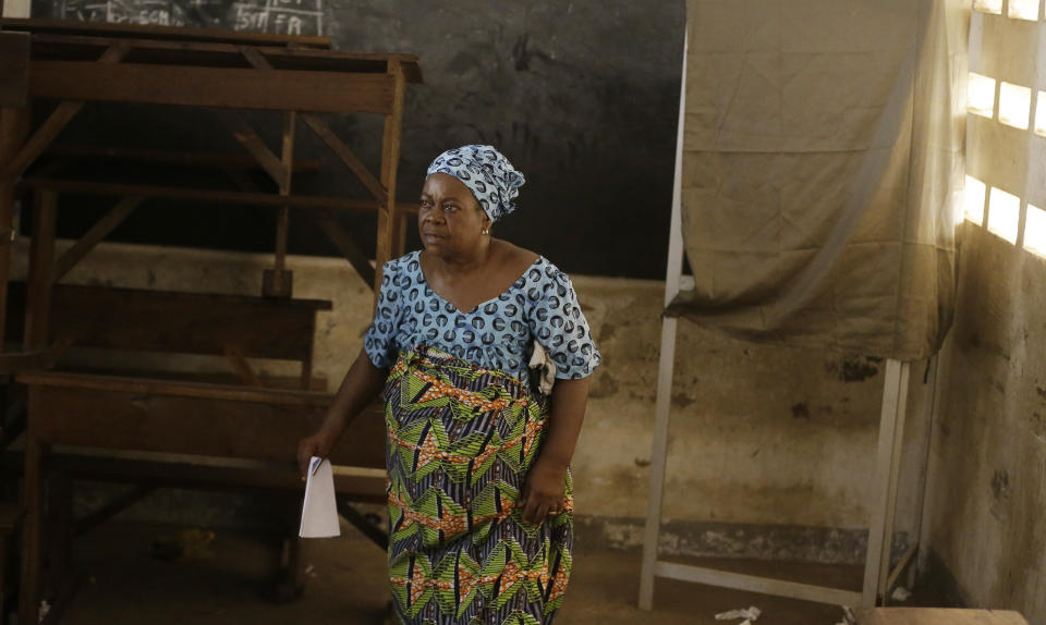 A woman exit a ballot booth after authenticating her ballot during the presidential election in Lome, Togo, Saturday, Feb. 22, 2020. The West African nation of Togo is voting Saturday in a presidential election that is likely to see the incumbent re-elected for a fourth term despite years of calls by the opposition for new leadership. (AP Photo/Sunday Alamba)