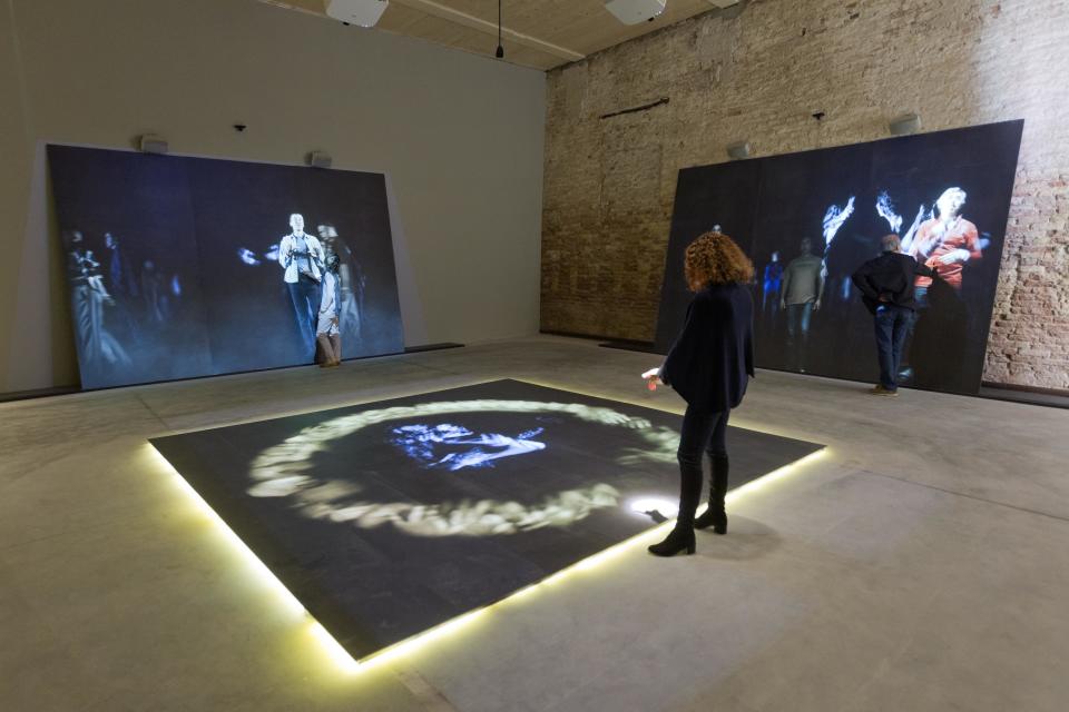 In this photo taken on Tuesday, May 28, 2013, members of Studio Azzurro activate their installation of touch-screen panels 'Creation' part of the Holy See Pavilion during a press preview of the 55th edition of the Venice Biennale of Arts in Venice, northern Italy.(AP Photo/Domenico Stinellis)