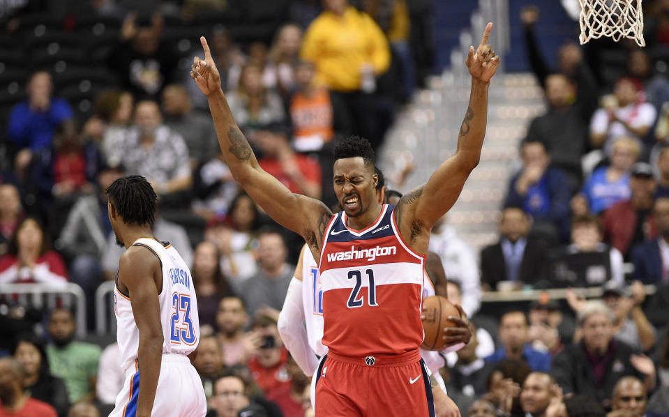 Washington Wizards center Dwight Howard (21) gestures after he dunked and was fouled during the first half of an NBA basketball game, as Oklahoma City Thunder guard Terrance Ferguson stands at left, Friday, Nov. 2, 2018, in Washington. (AP Photo/Nick Wass)