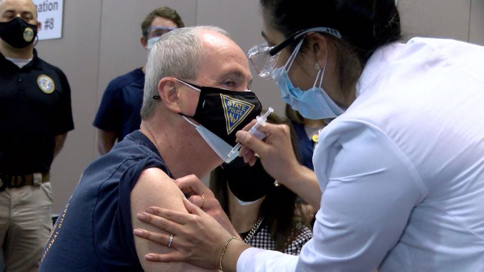 New Jersey Gov. Phil Murphy gets his first dose of the Pfizer COVID-19 vaccine administered by AtlantiCare RN Neha Desai at the Atlantic City, N.J., megasite Friday.