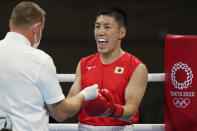 Japan's Daisuke Narimatsu is checked by the referee before the start of his men's lightweight 63-kg boxing match with Fiston Mbaya Mulumba, of the Democratic Republic of the Congo, at the 2020 Summer Olympics, Sunday, July 25, 2021, in Tokyo, Japan. (AP Photo/Frank Franklin II)