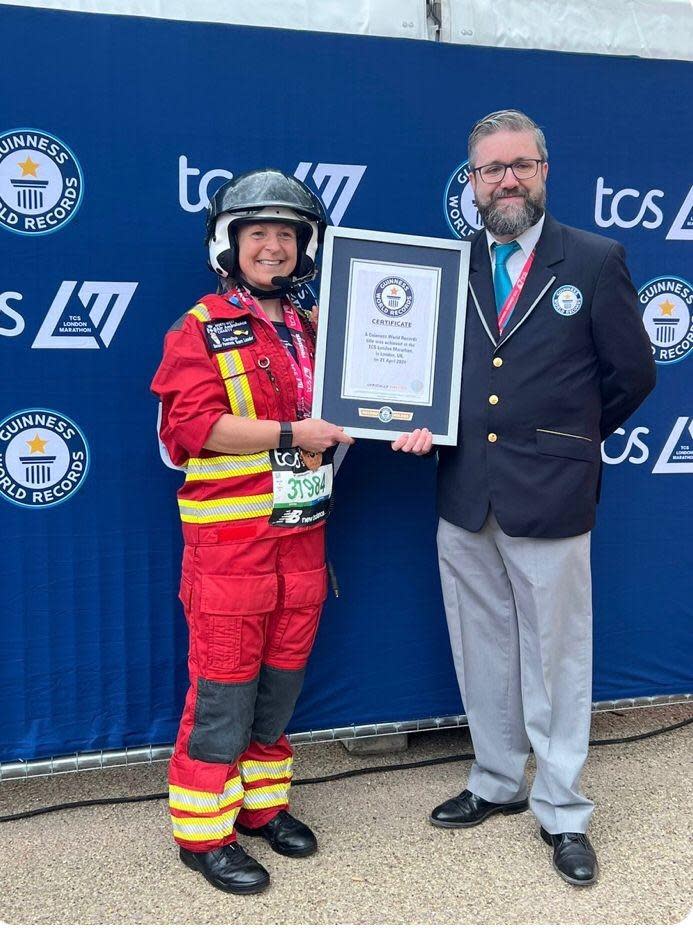 Lancashire Telegraph: Caroline Duncan recieving her Guinness World Record certificate after running the London Marathon