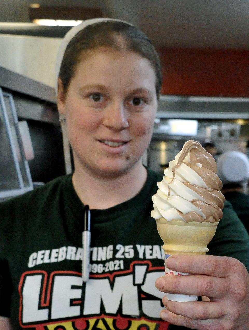 Miriam Hostetler holds a vanilla and chocolate twist cone. She works at Lems in Fredericksburg where they have 24 flavors of soft-serve ice cream.