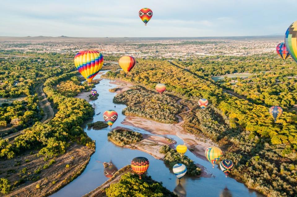 Hot air balloons floating over New Mexico from an aerial view