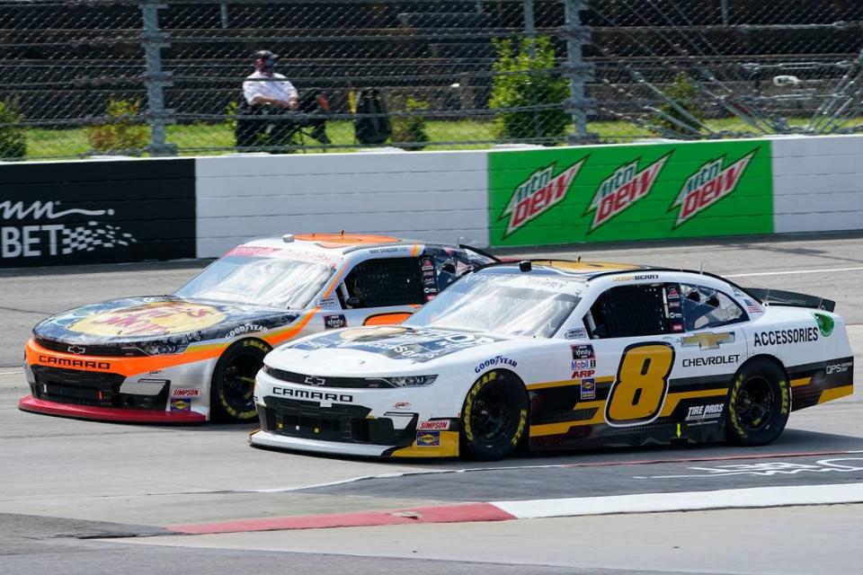 Josh Berry (8) and Noah Gragson, left, drive into turn turn two during start of the rain delayed NASCAR Xfinity Series auto race at Martinsville Speedway in Martinsville, Va., Sunday, April 11, 2021. (AP Photo/Steve Helber)