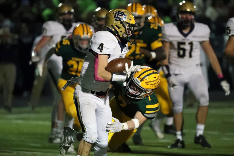 Grosse Pointe North's Charlie Auld tackles Grosse Pointe South's Egan Sullivan during first-half action on Friday, Oct. 21, 2022.