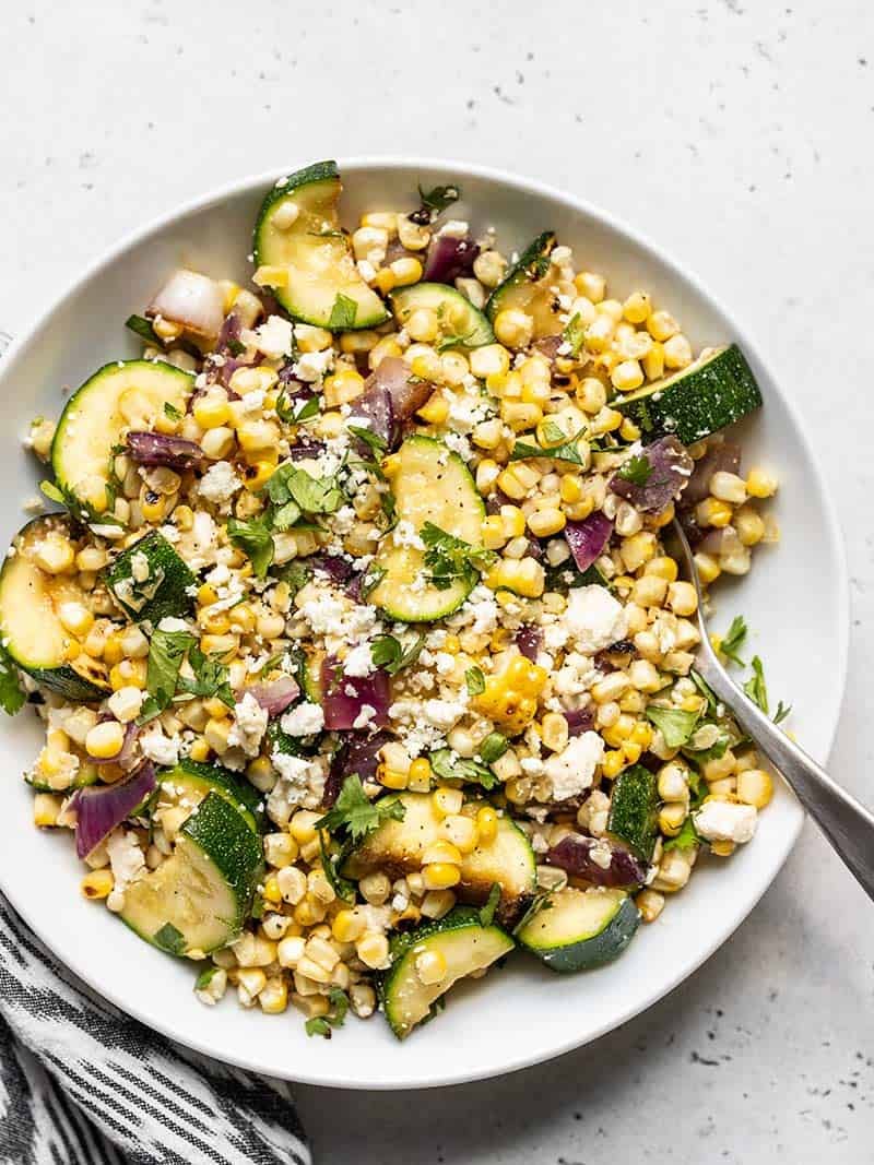 <p>Natural juices from the veggies—plus feta cheese and some salt and pepper—make this salad super flavorful without an ounce of dressing needed.</p> <p>Get the recipe <a href="https://www.budgetbytes.com/charred-corn-and-zucchini-salad/" rel="nofollow noopener" target="_blank" data-ylk="slk:here;elm:context_link;itc:0;sec:content-canvas" class="link ">here</a>.</p>