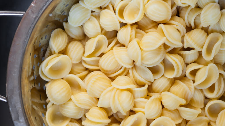 cooked orecchiette pasta dining in colander 