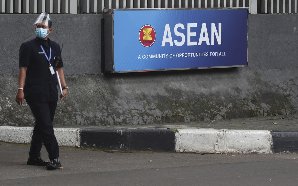 A security person stands outside the Association of Southeast Asian Nations (ASEAN) Secretariat in Jakarta, Indonesia, Monday, Oct. 25, 2021. Southeast Asian leaders are meeting this week for their annual summit where Myanmar's top general, whose forces seized power in February and shattered one of Asia's most phenomenal democratic transitions, has been shut out for refusing to take steps to end the deadly violence. (AP Photo/Achmad Ibrahim)