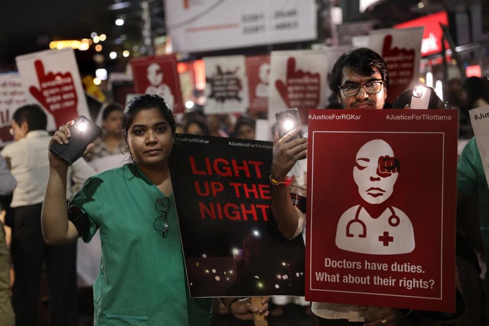 Medical students, doctors and members of the civil society attend a candlelight protest march as they demand justice after an alleged rape and murder incident in Kolkata, India, on 23 August 2024 (EPA)