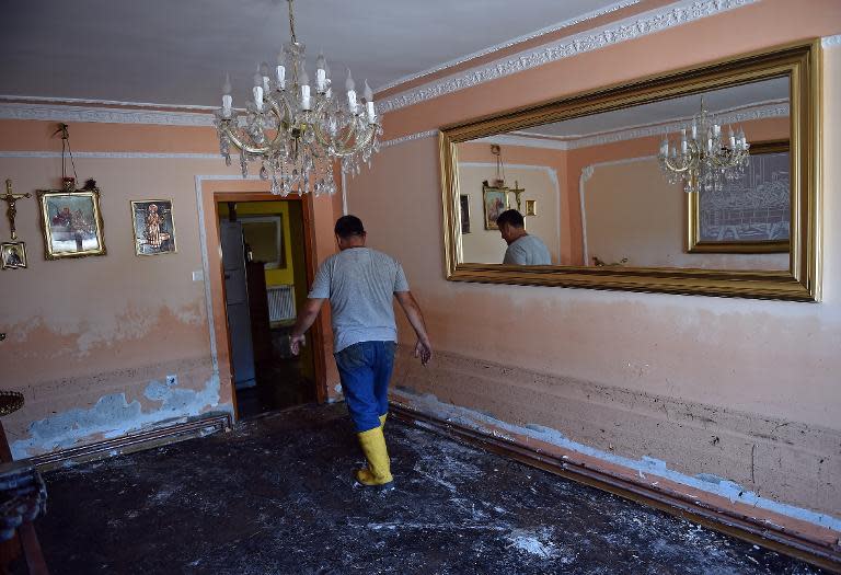 A man walks out of his flooded living room in in the village of Maljurevac, near Pozarevac, Serbia on May 23, 2014