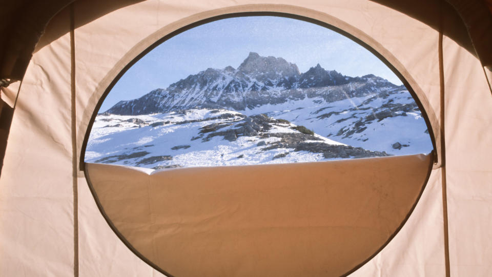 View of a mountain through a tent door