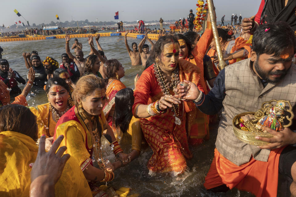In this Jan. 15, 2019, photo, Laxmi Narayan Tripathi, center right, an Indian transgender activist and leader of the Kinnar Akhara monastic order, takes a dip along with other members of the order on the auspicious Makar Sankranti day during the Kumbh Mela festival in Prayagraj, Uttar Pradesh state, India. This is the first time Tripathi’s newly formed Kinnar Akhara has set up camp at the massive temporary city in Prayagraj. The Kinnars’ tent camp on the edge of the festival grounds is adorned with Ardhanari, the androgynous composite image of the Hindu god Shiva and his consort Parvati, that religious scholars date to the 1st century. (AP Photo/Bernat Armangue)