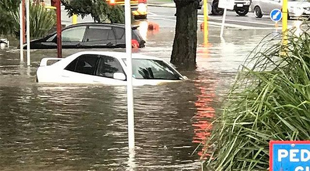 New Lynn centre has suffered from flash floods, with cars fully submerged. Photo: New Lynn Facebook page.