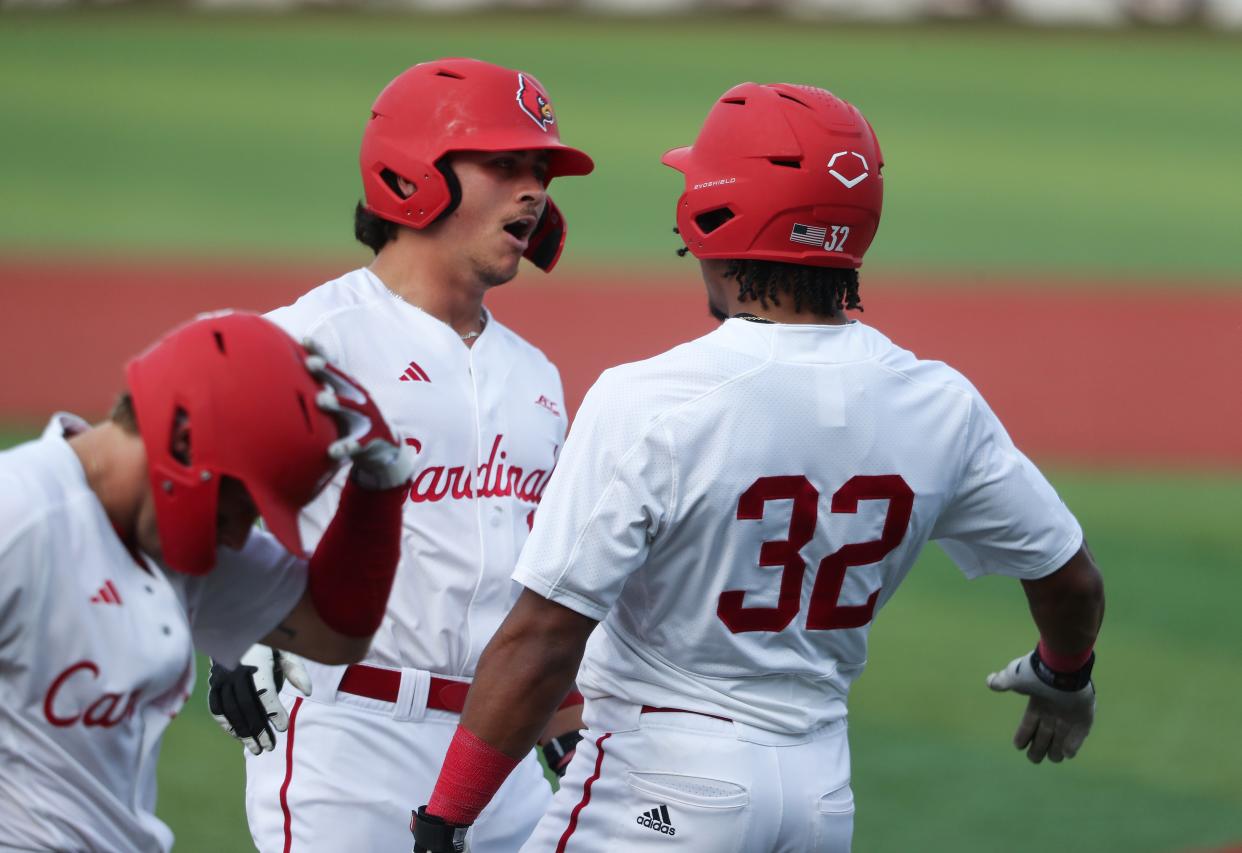 Louisville's JT Benson celebrates with teammate Zion Rose (32) after Benson hit a home run against Kentucky on April 16.
