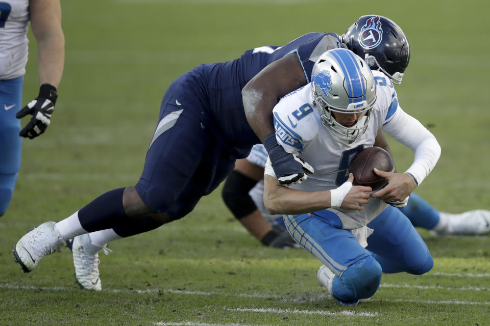 Detroit Lions quarterback Matthew Stafford is tackled by Tennessee Titans defensive tackle Teair Tart during the second half of an NFL football game Sunday, Dec. 20, 2020, in Nashville, N.C. (AP Photo/Ben Margot)