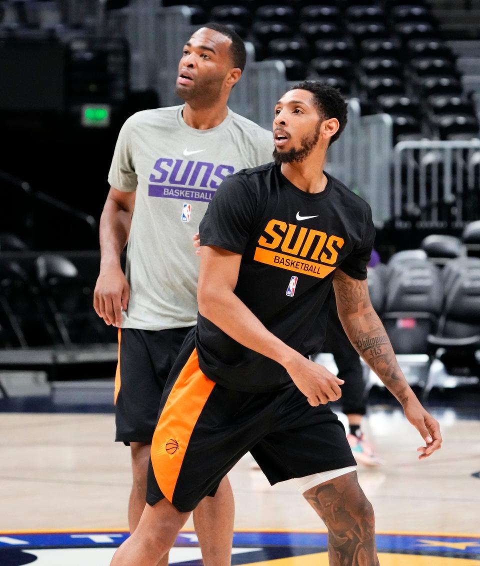 Phoenix Suns guard Cameron Payne and forward T.J. Warren during a Friday practice in Denver on April 28, 2023, as the team prepares for the Western Conference Semifinals against the Denver Nuggets at Ball Arena.