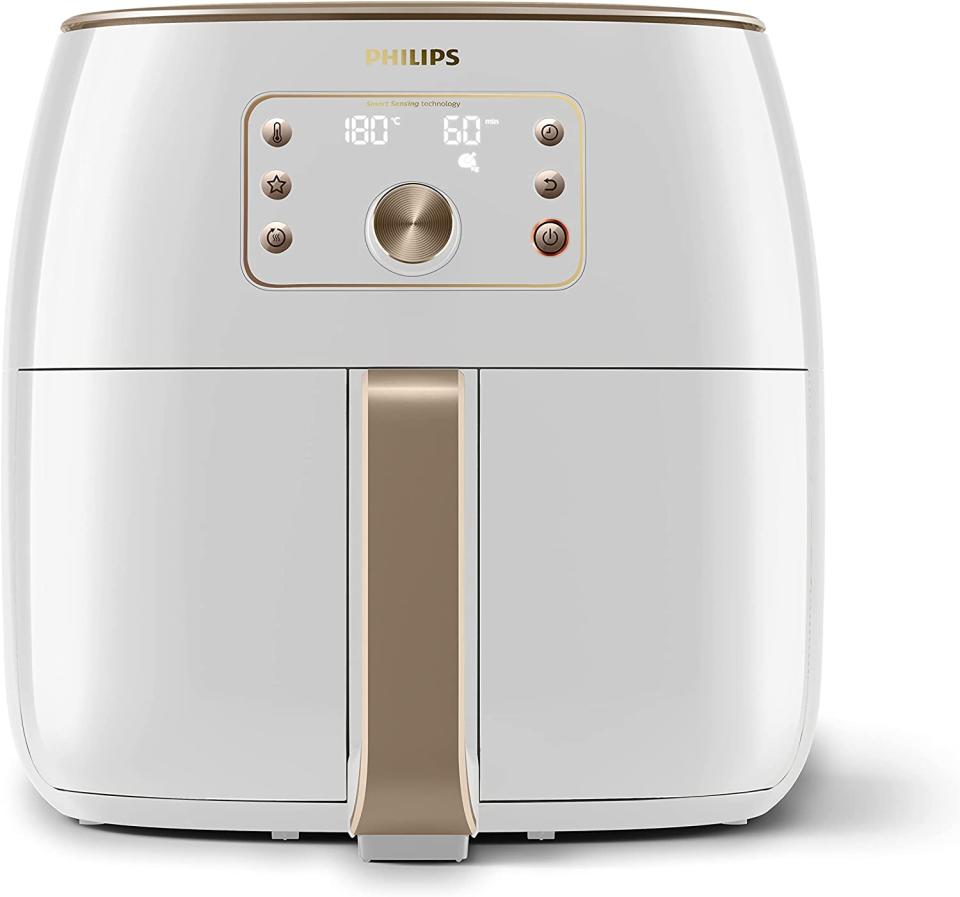 A white and gold Philips XXL Airfryer with Smart Sensing Technology on a white background