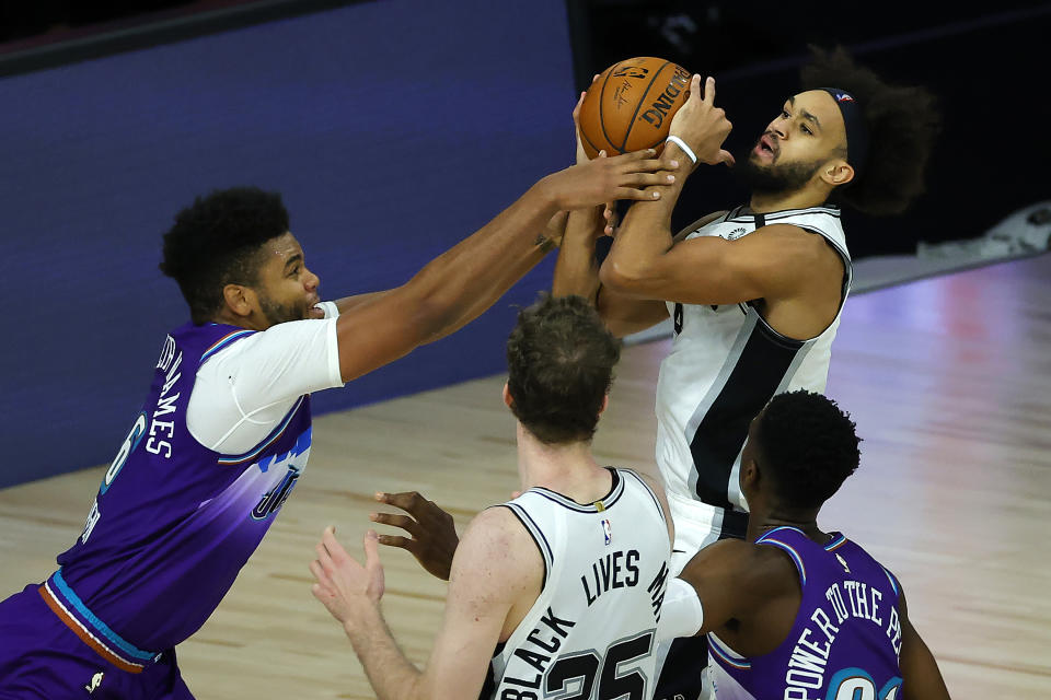 Utah Jazz' Juwan Morgan (16), fouls San Antonio Spurs' Derrick White during second half of an NBA basketball game Friday, Aug. 7, 2020, in Lake Buena Vista, Fla. (Kevin C. Cox/Pool Photo via AP)