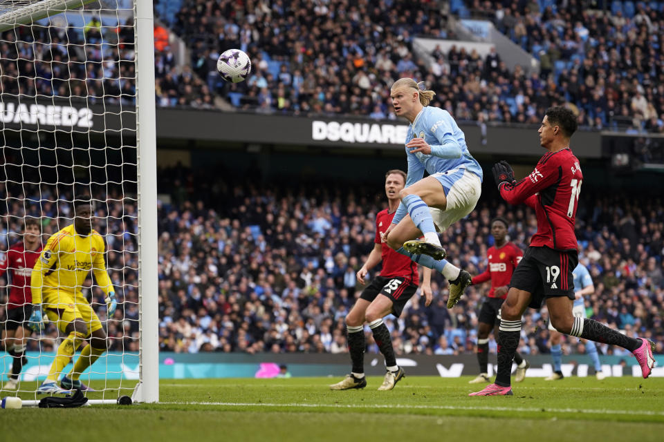 Manchester City's Erling Haaland, centre tries to score during an English Premier League soccer match between Manchester City and Manchester United at the Etihad Stadium in Manchester, England, Sunday, March 3, 2024. (AP Photo/Dave Thompson)