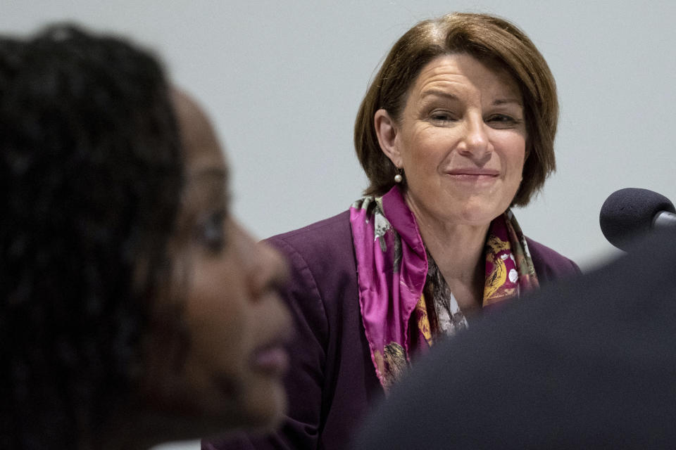 Sen. Amy Klobuchar, D-Minn. listens to a person talk about how long she waited in line to vote, in Smyrna, Ga., Sunday, July 18, 2021. Klobuchar was in Georgia ahead of a rare field hearing of the Senate Rules Committee, which will be held Monday at the National Center for Civil and Human Rights. (AP Photo/Ben Gray)