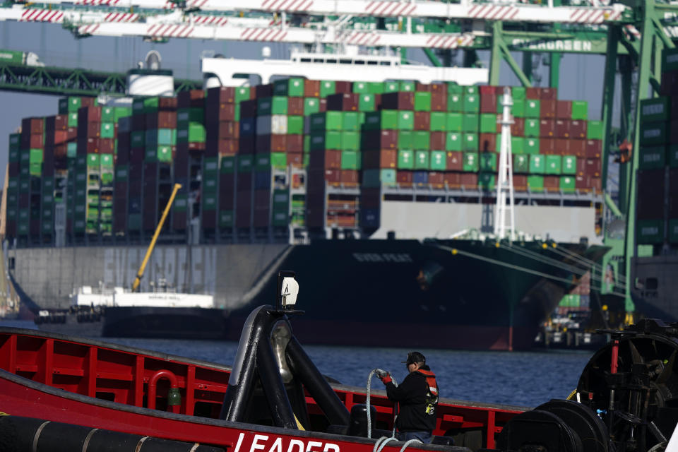 FILE - A worker is seen in a tug boat at the Port of Los Angeles on Nov. 10, 2021, in Los Angeles. The Port of Los Angeles is on track to move a record volume of import cargo this year. Officials at the nation's busiest port expect to hit the new mark, even as they struggle to clear a backup of ship traffic and ease supply chain snarls that have been blamed for product shortages and higher shelf prices. (AP Photo/Marcio Jose Sanchez, File)