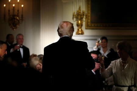 U.S. President Donald Trump stands during a toast giving by Virginia Governor Terry McAuliffe during the Governor's Dinner in the State Dining Room at the White House in Washington, U.S., February 26, 2017. REUTERS/Joshua Roberts