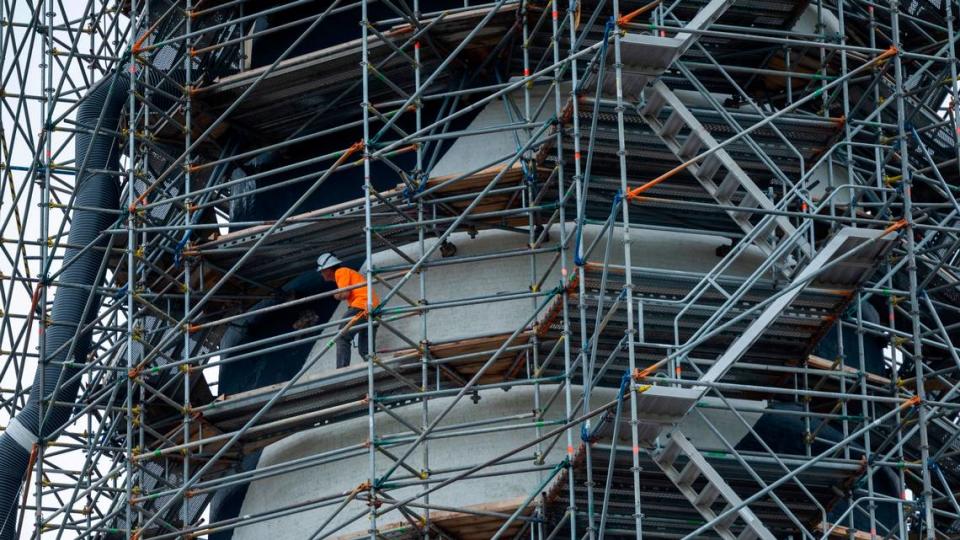 A worker navigates the scaffolding surrounding the Cape Hatteras Lighthouse during a restoration project on Monday, July 1, 2024. The project is expected to cost $19.2 million and will include replacing 40,000 of its estimated 1,250,000 bricks, replacing rusted or broken metal components and the installation of a near-exact replica of the first-order Fresnel lens.