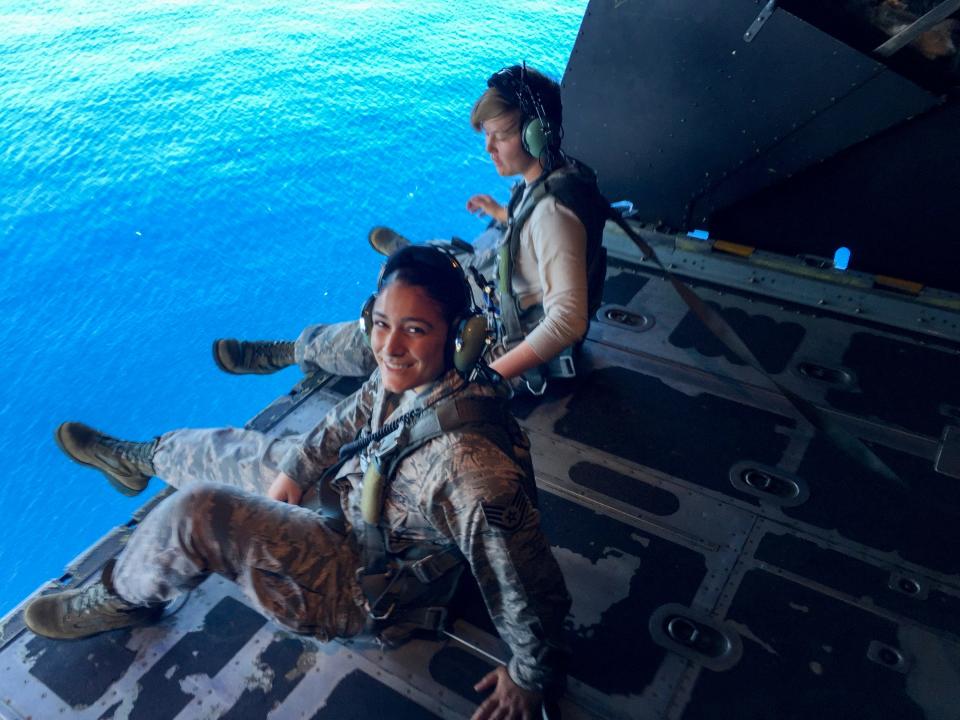 Ever the adventurer, Tech. Sgt. Amalya Velez, front, is shown aboard an Air Force C-130 with Senior Airman Dalen Payne, who she trained in San Antonio, circling the island of Okinawa, Japan.