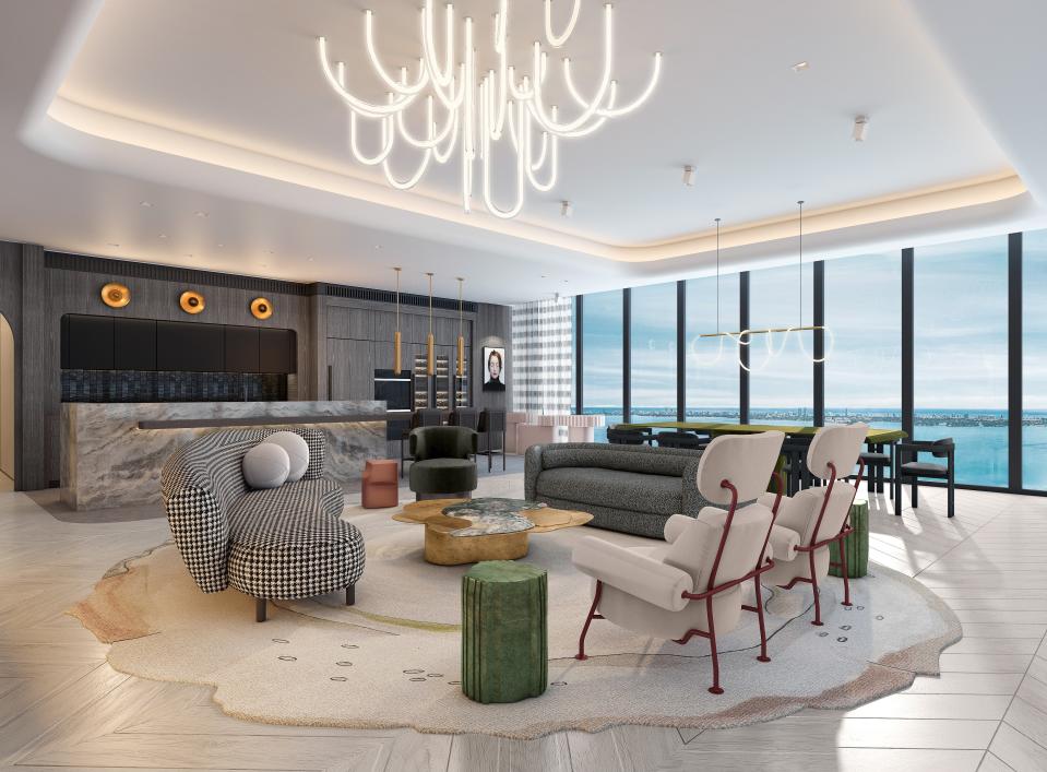 Guidon Studio embraced the allure of Miami's skyline and ocean vistas when creating this stunning living room oasis. It showcases a kitchen with natural stone and darker materials that serve as a backdrop for the unique furniture layout and distinctive light fixtures.