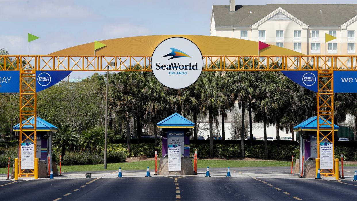 The entrance to the SeaWorld Theme park remains closed, in Orlando, Fla.